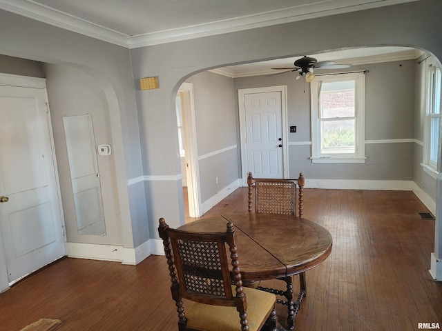 dining room with hardwood / wood-style flooring, arched walkways, and ceiling fan