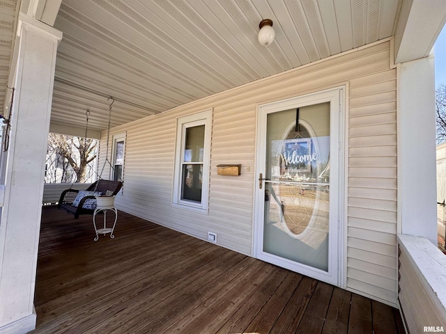 wooden terrace featuring covered porch