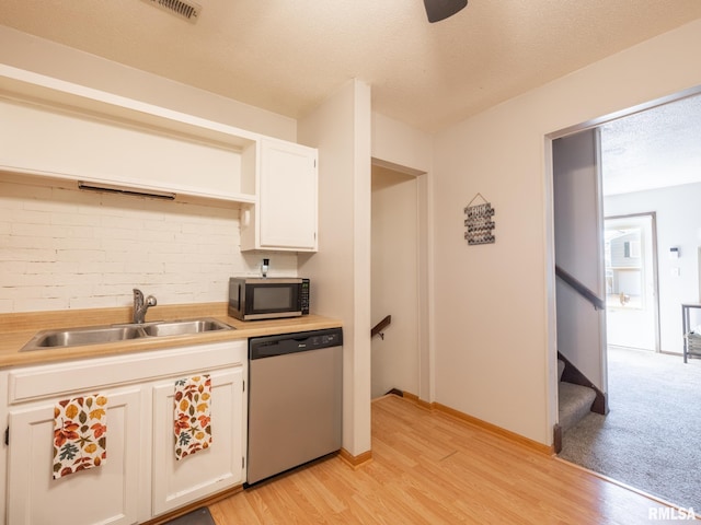 kitchen featuring a sink, light countertops, white cabinetry, and stainless steel appliances