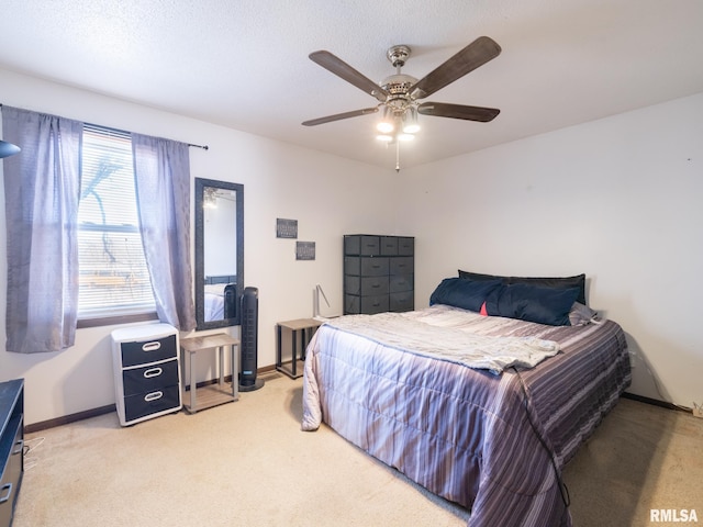 bedroom with baseboards, light colored carpet, and ceiling fan