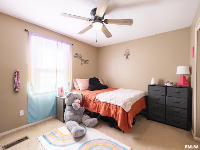 bedroom featuring visible vents, light carpet, baseboards, and a ceiling fan