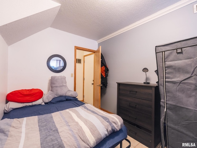 bedroom featuring crown molding, vaulted ceiling, visible vents, and a textured ceiling