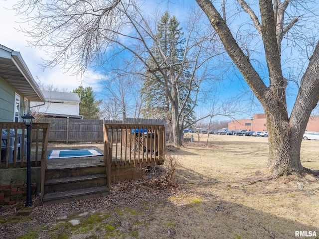 view of yard featuring a fenced in pool and fence