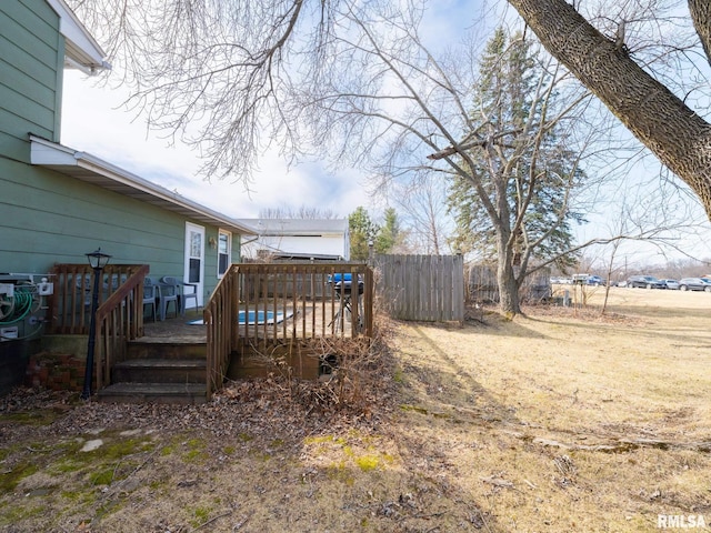 view of yard with a deck and fence