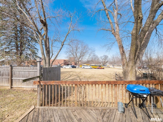 wooden deck with area for grilling and fence