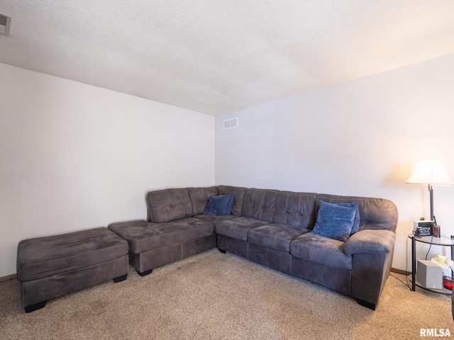 living room featuring light carpet, visible vents, and a textured ceiling