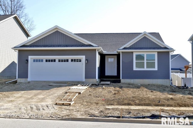 view of front of property featuring driveway, board and batten siding, and an attached garage