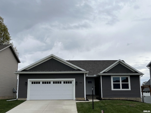 ranch-style house featuring a garage, board and batten siding, concrete driveway, and a front lawn