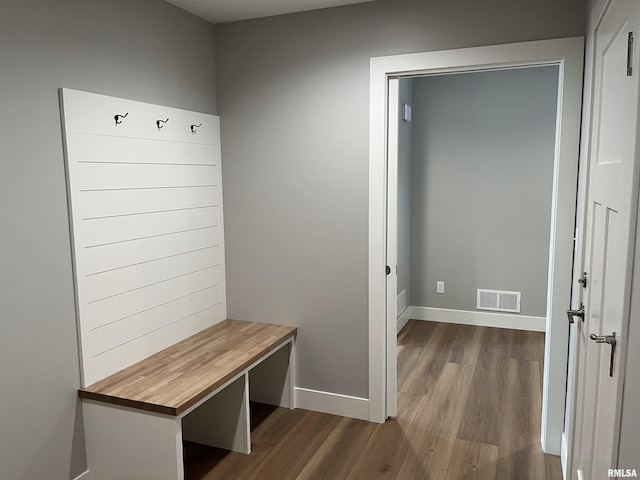 mudroom featuring baseboards, dark wood finished floors, and visible vents
