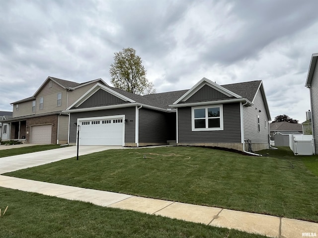view of front of house with concrete driveway, an attached garage, and a front lawn