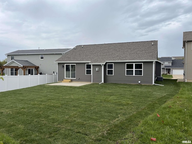 back of house with a gazebo, fence, a yard, a patio, and a shingled roof