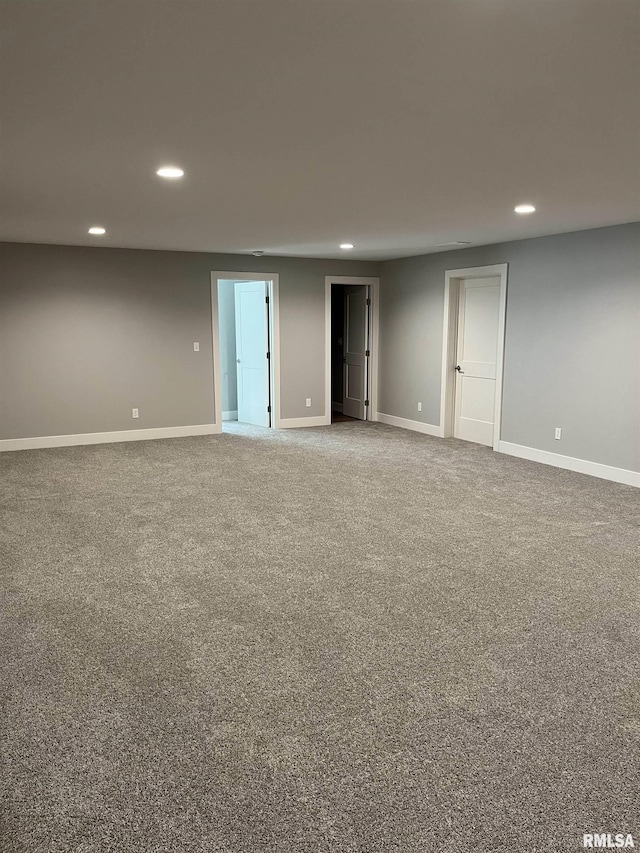 empty room featuring baseboards, carpet flooring, and recessed lighting