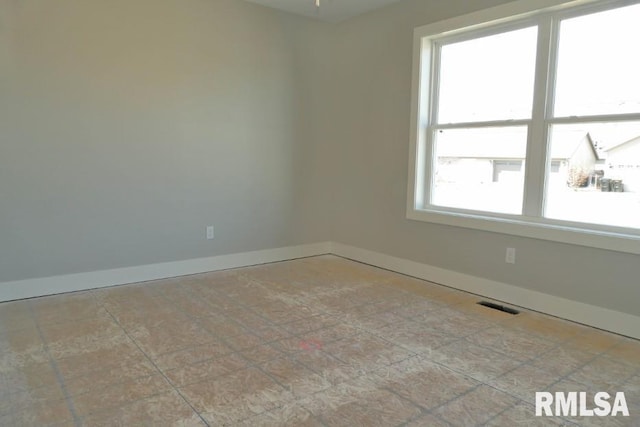 spare room with visible vents and baseboards