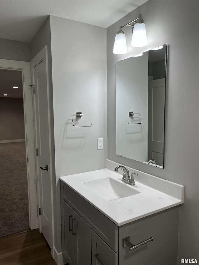 bathroom with vanity and wood finished floors