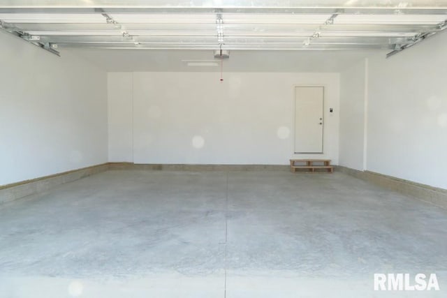 garage featuring baseboards and a garage door opener