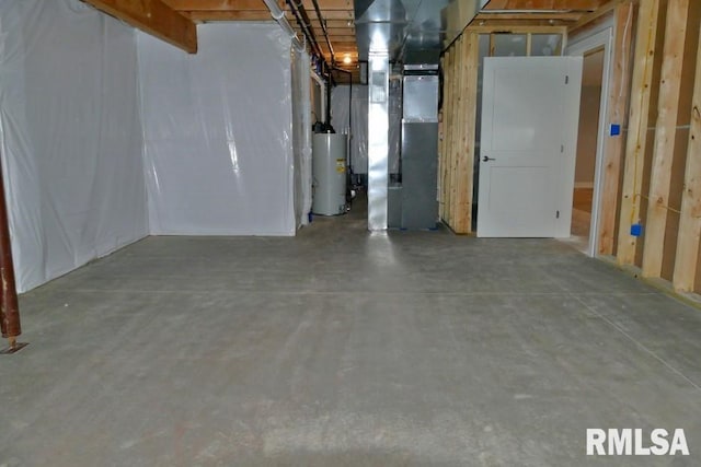 unfinished below grade area featuring water heater