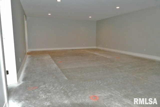 spare room featuring recessed lighting, baseboards, and concrete floors