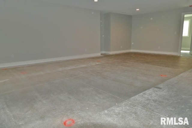 unfurnished room with recessed lighting, baseboards, and concrete floors