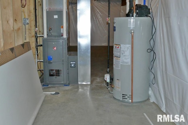 utility room featuring heating unit and gas water heater