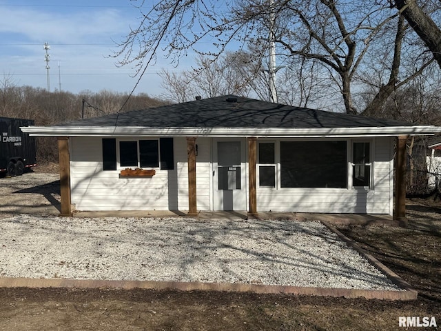 exterior space with covered porch and a shingled roof