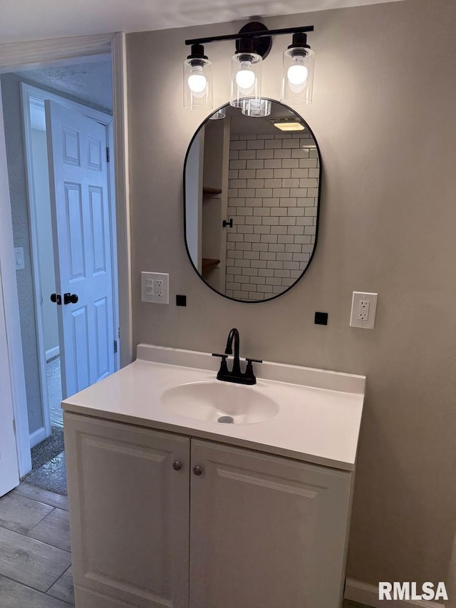 bathroom with wood finished floors and vanity