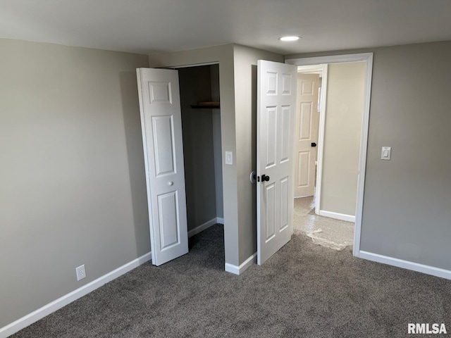 unfurnished bedroom with carpet flooring and baseboards