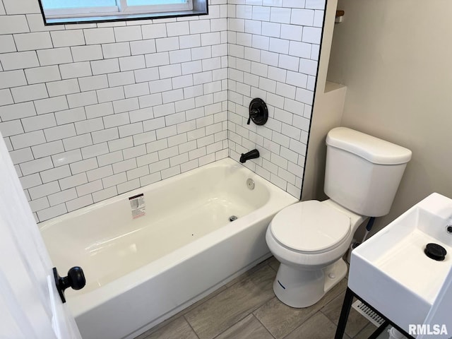 bathroom with toilet and shower / bathtub combination