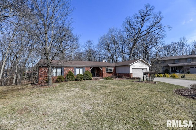 single story home featuring a garage, a front lawn, brick siding, and driveway