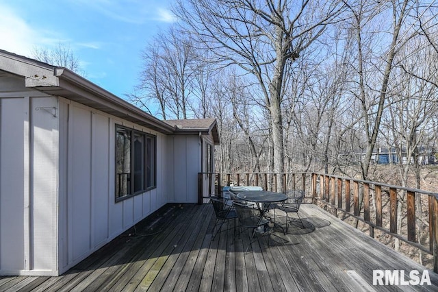 wooden deck featuring outdoor dining area