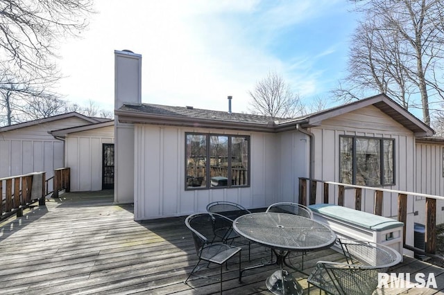 wooden terrace with outdoor dining area