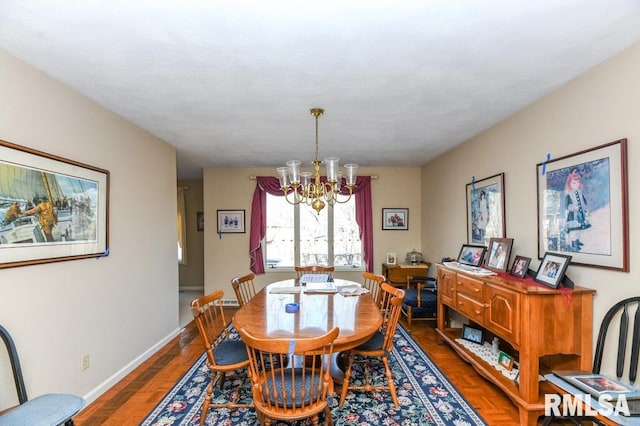 dining area with a notable chandelier and baseboards