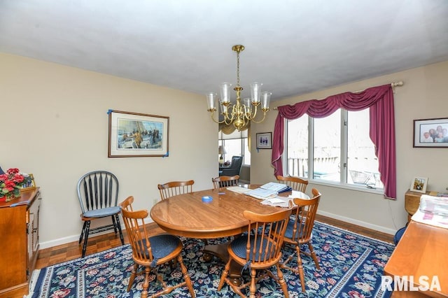 dining space featuring a wealth of natural light, baseboards, and a chandelier