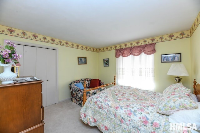 bedroom with light carpet and a closet