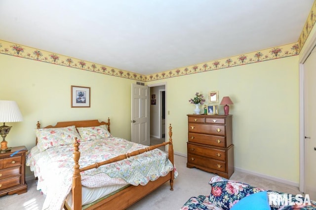 bedroom featuring light colored carpet and baseboards