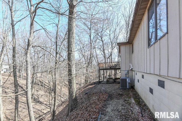 view of home's exterior featuring crawl space, board and batten siding, and central AC