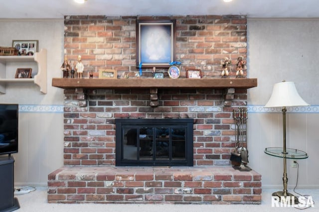 interior details featuring crown molding and a brick fireplace