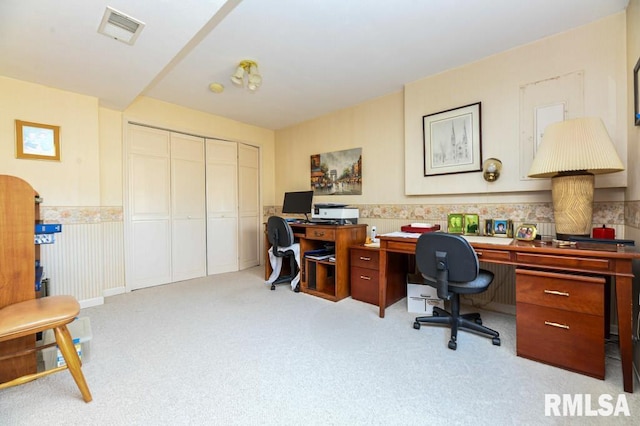 carpeted office with visible vents and wainscoting