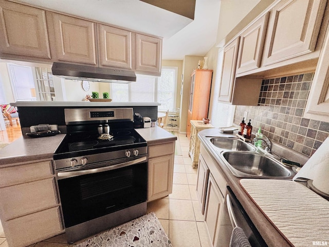 kitchen featuring stainless steel electric range oven, light tile patterned floors, a sink, under cabinet range hood, and tasteful backsplash