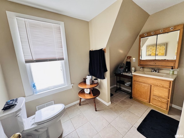 half bathroom with vanity, visible vents, baseboards, tile patterned floors, and toilet