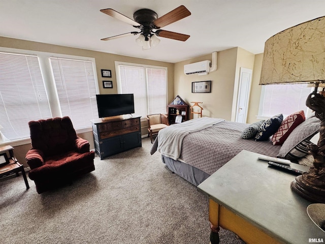 bedroom with ceiling fan, carpet, and a wall unit AC