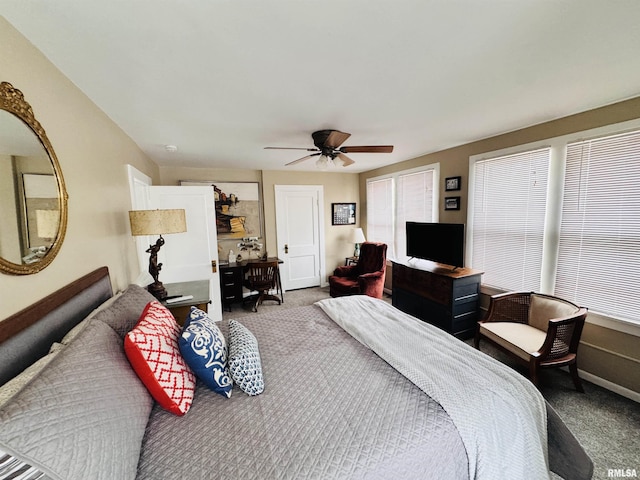 carpeted bedroom featuring multiple windows, baseboards, and ceiling fan