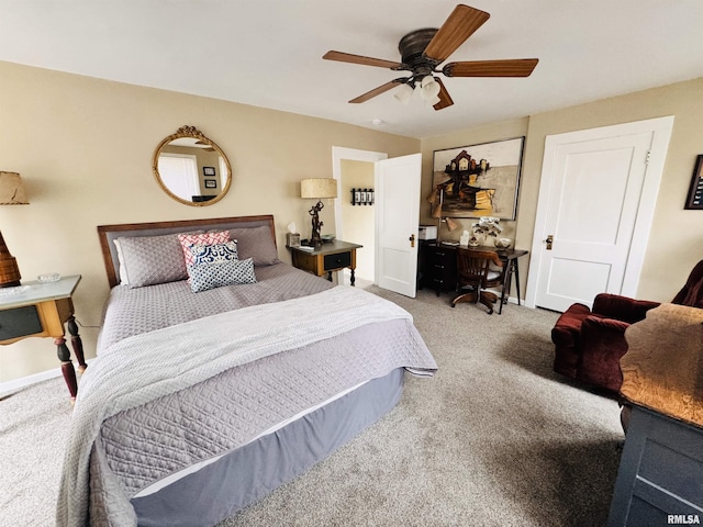 carpeted bedroom with a ceiling fan and baseboards