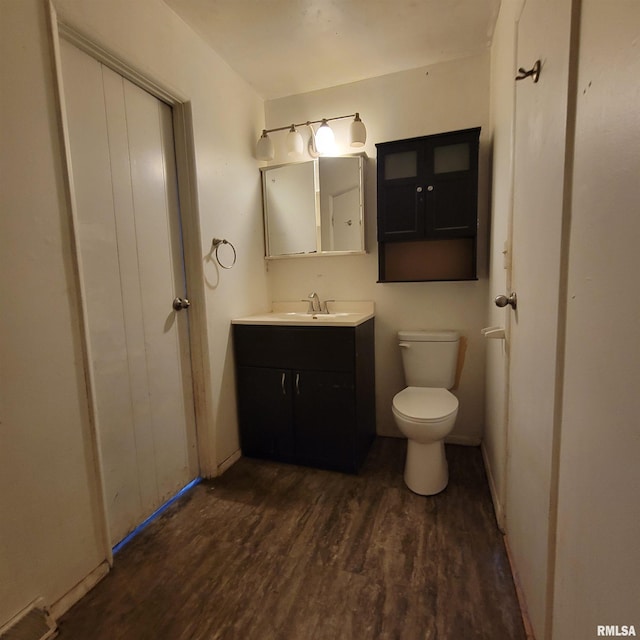 bathroom with visible vents, toilet, vanity, and wood finished floors