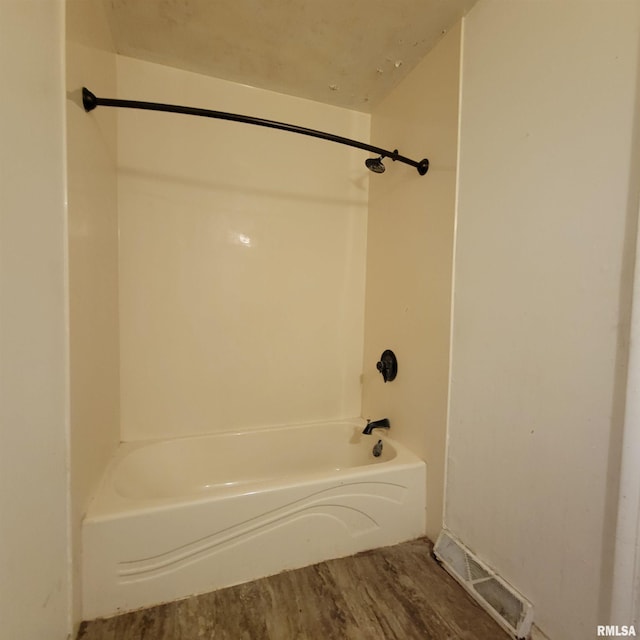 full bath featuring shower / tub combination, wood finished floors, and visible vents