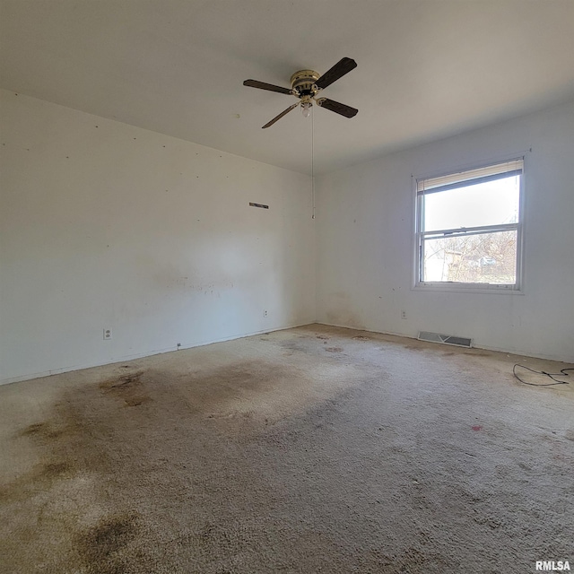 empty room featuring visible vents and a ceiling fan