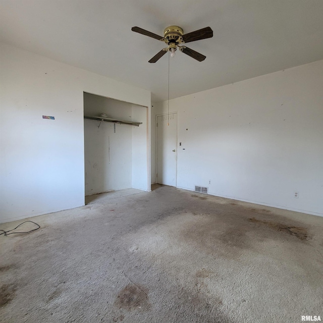 unfurnished bedroom with visible vents, light colored carpet, a closet, and ceiling fan