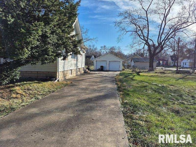 view of side of home with an outbuilding, a yard, and a garage