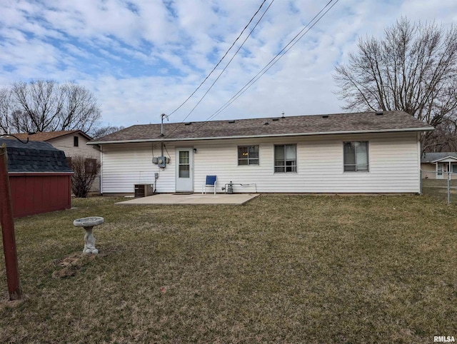 rear view of property featuring a yard, a patio, an outbuilding, and a shed