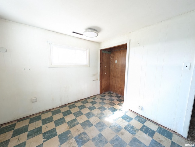 unfurnished bedroom with tile patterned floors and visible vents