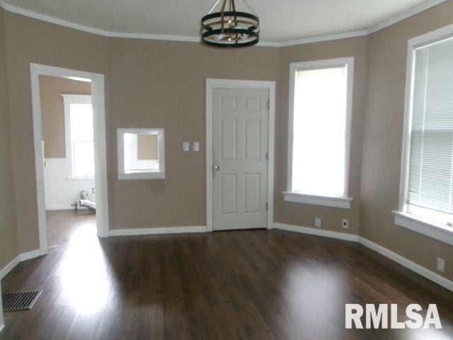 1209 S 4th St, Pekin, IL 61554 - unfurnished room featuring a chandelier, ornamental molding, and wood finished floors